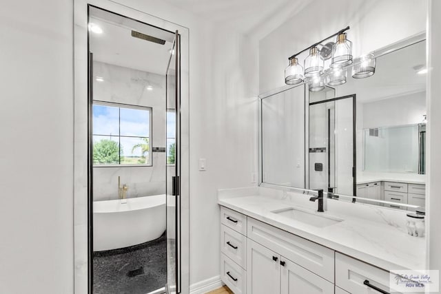 bathroom featuring a washtub and vanity