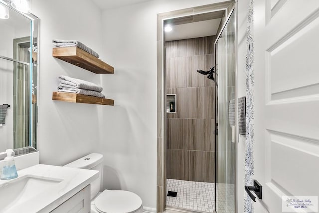 bathroom with vanity, toilet, and walk in shower