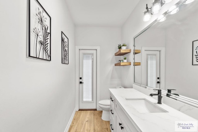 bathroom with hardwood / wood-style floors, vanity, and toilet