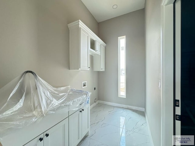 laundry area with hookup for an electric dryer, cabinets, and hookup for a washing machine