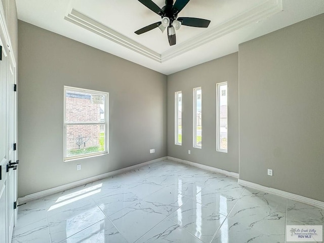 unfurnished room featuring ceiling fan and a raised ceiling