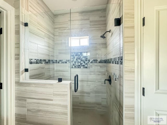 bathroom featuring a shower with door