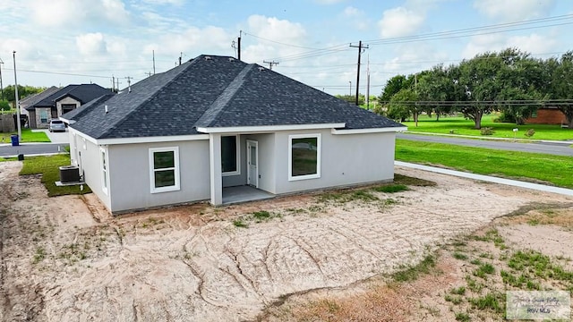 rear view of house featuring central air condition unit and a patio area