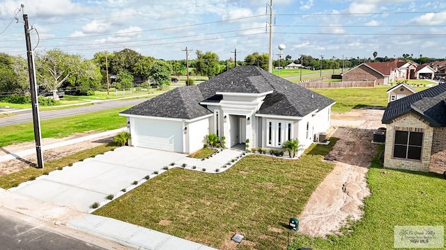 view of front facade with central AC, a front lawn, and a garage