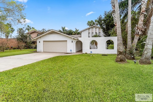 view of front of property with a front yard and a garage