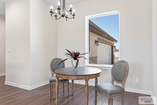 dining room with a notable chandelier, baseboards, and wood finished floors