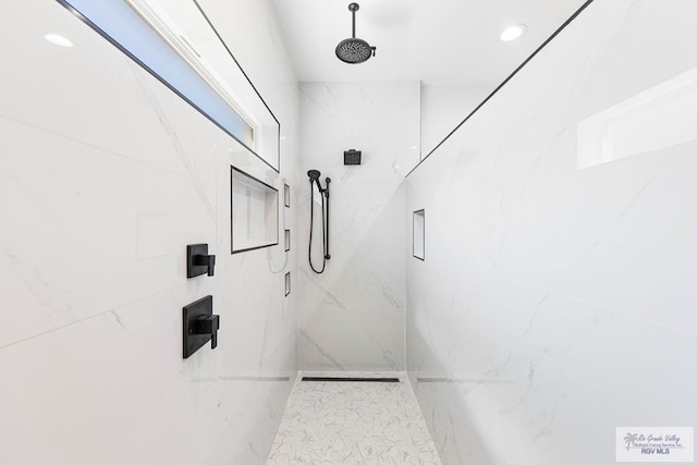 bathroom with recessed lighting and a marble finish shower