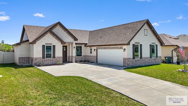 view of front of home with driveway, a front yard, brick siding, and an attached garage