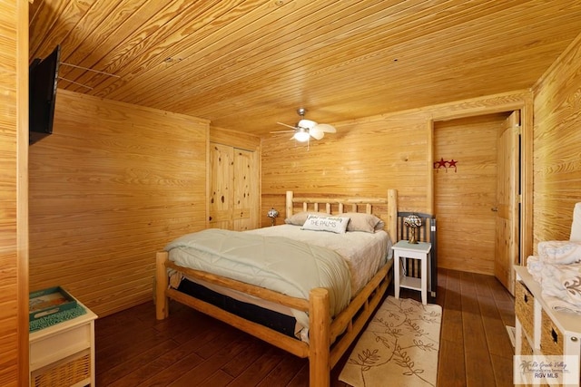 bedroom with wood-type flooring, wood ceiling, ceiling fan, and wood walls