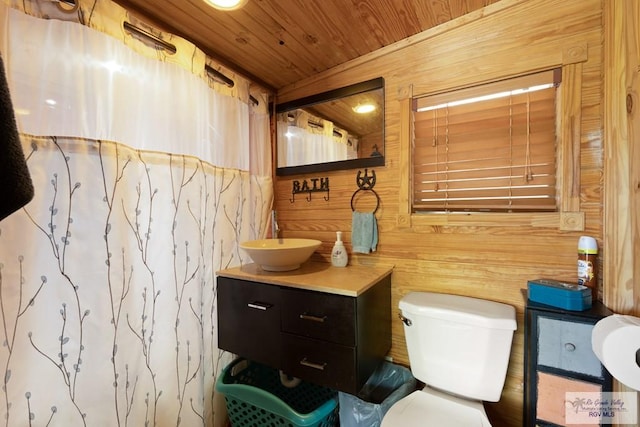 bathroom with vanity, wooden walls, a shower with shower curtain, toilet, and wood ceiling