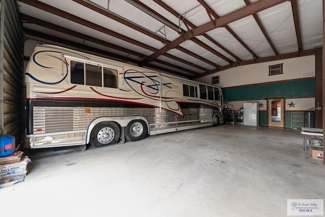 garage featuring a workshop area and a carport