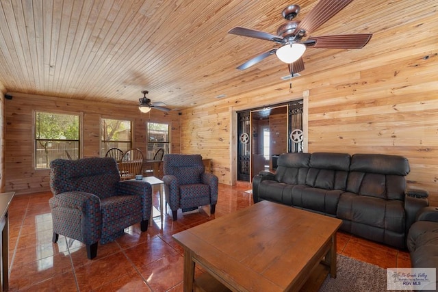 tiled living room with wooden walls, ceiling fan, and wooden ceiling