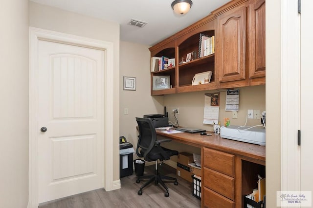 office with light hardwood / wood-style floors