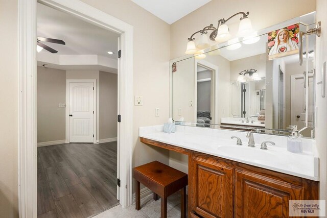 bathroom featuring hardwood / wood-style floors, vanity, and ceiling fan