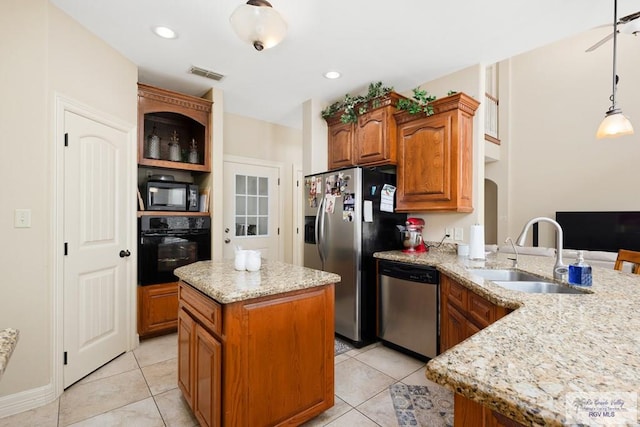 kitchen with pendant lighting, black appliances, sink, a kitchen island, and kitchen peninsula