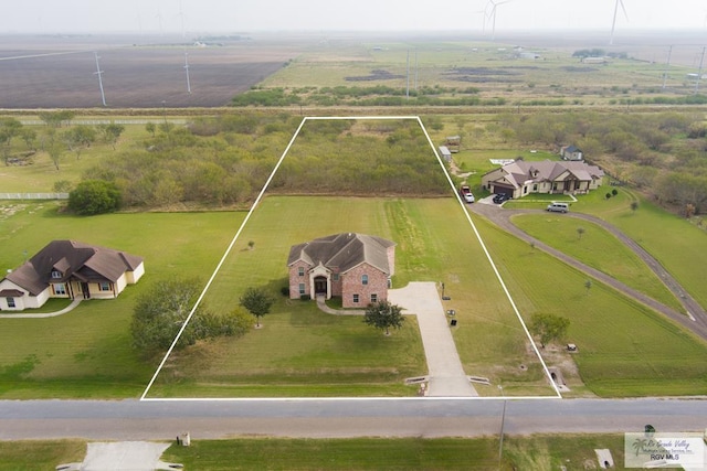 birds eye view of property with a rural view