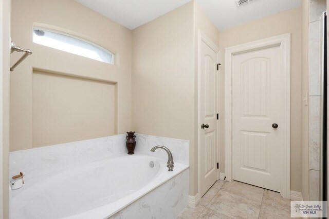 bathroom featuring a tub to relax in