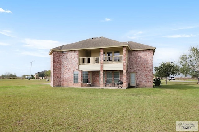 back of house featuring a yard and a balcony