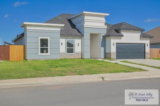 view of front facade with a front yard and a garage