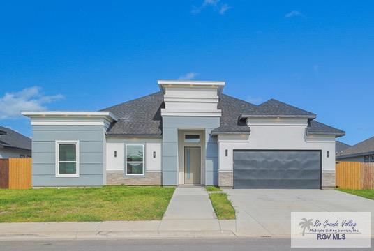 view of front of house with a garage and a front lawn