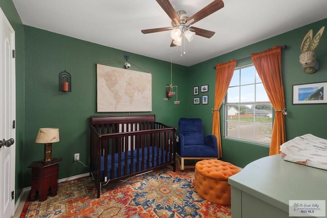 bedroom featuring baseboards and a ceiling fan