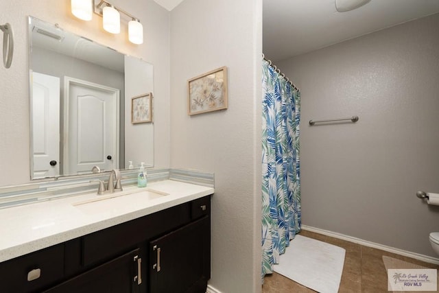 full bath with visible vents, toilet, tile patterned flooring, baseboards, and vanity