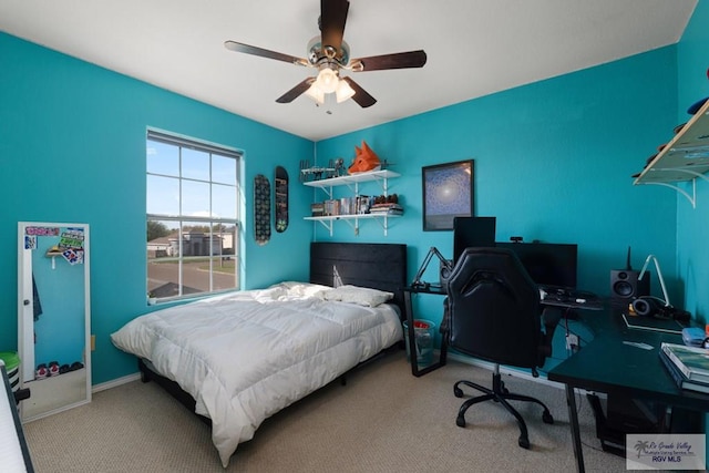 bedroom featuring a ceiling fan, carpet, and baseboards