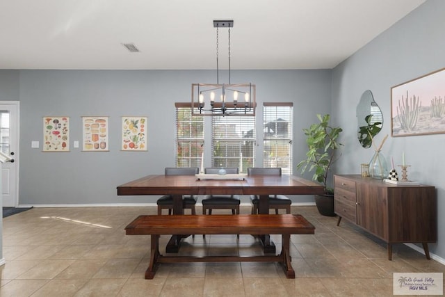 dining space with an inviting chandelier, baseboards, and visible vents