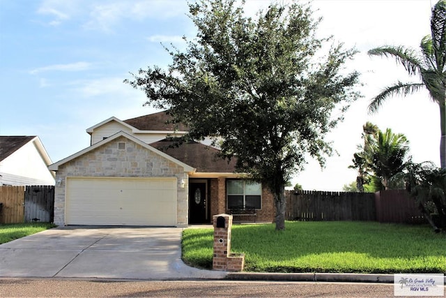 view of front facade featuring a front yard, driveway, an attached garage, and fence