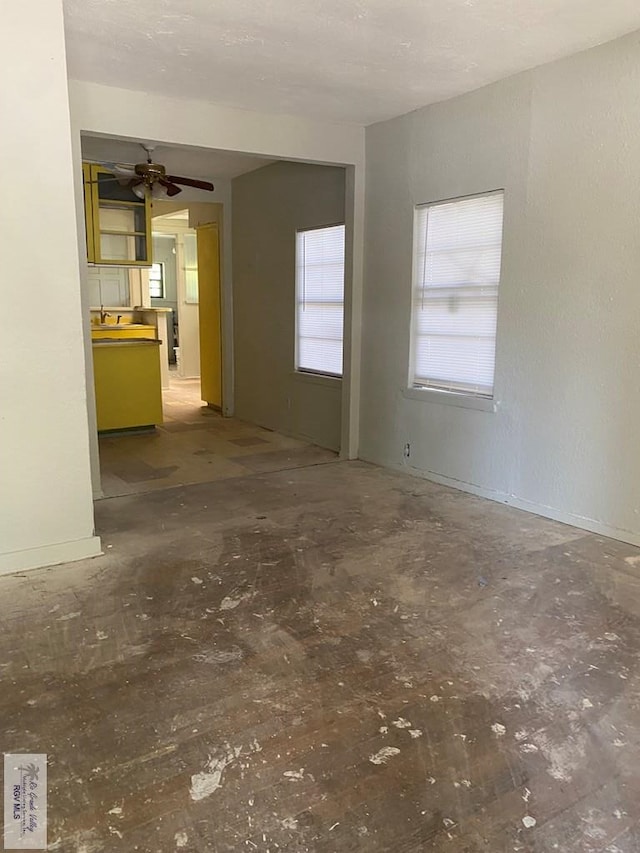 610 Charlotte St, San Benito, TX 78586 - unfurnished living room featuring a ceiling fan and unfinished concrete floors