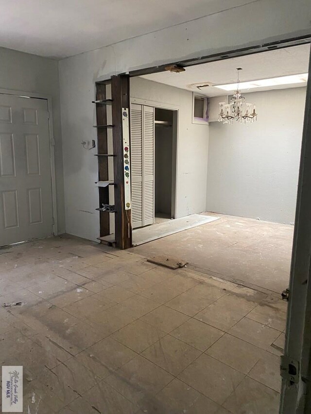 610 Charlotte St, San Benito, TX 78586 - empty room with a chandelier