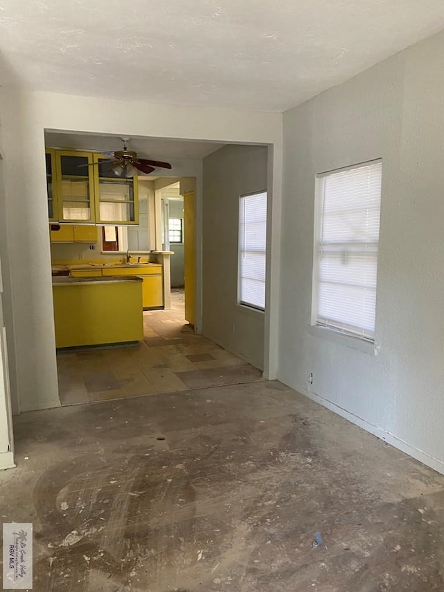 610 Charlotte St, San Benito, TX 78586 - unfurnished living room featuring a ceiling fan and a sink