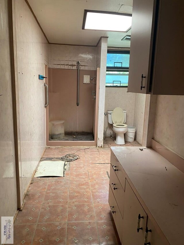610 Charlotte St, San Benito, TX 78586 - bathroom featuring a stall shower, toilet, and vanity