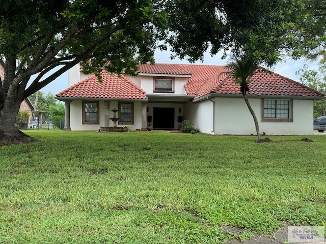 mediterranean / spanish-style home with a front yard