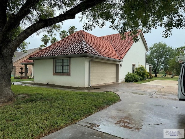 view of home's exterior with a yard and a garage