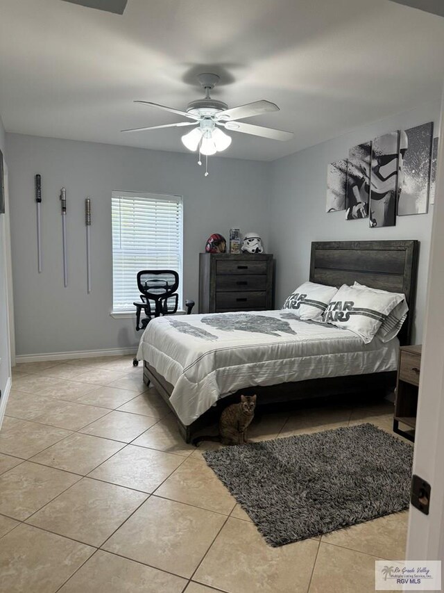 tiled bedroom featuring ceiling fan