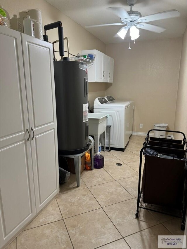 laundry area with cabinets, washer and dryer, ceiling fan, light tile patterned floors, and water heater