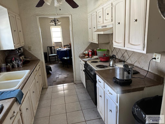 kitchen with light tile patterned floors, sink, ceiling fan, electric range, and tasteful backsplash