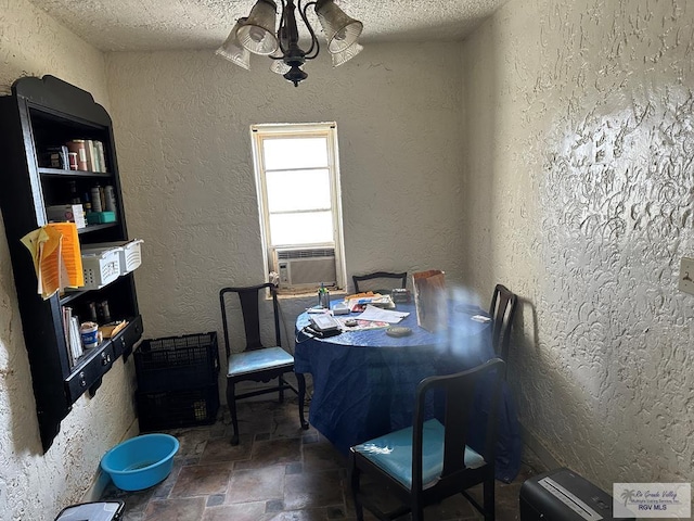 dining room with cooling unit, a chandelier, and a textured ceiling