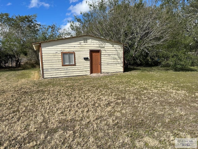 view of outbuilding featuring a lawn