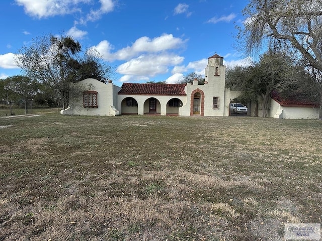 mediterranean / spanish-style house with a front yard