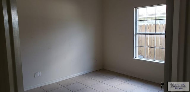 spare room featuring light tile patterned flooring