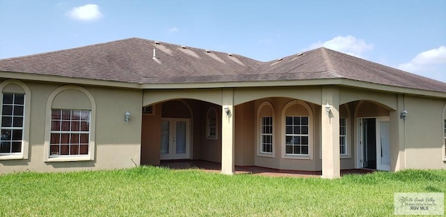 back of house with a yard and french doors