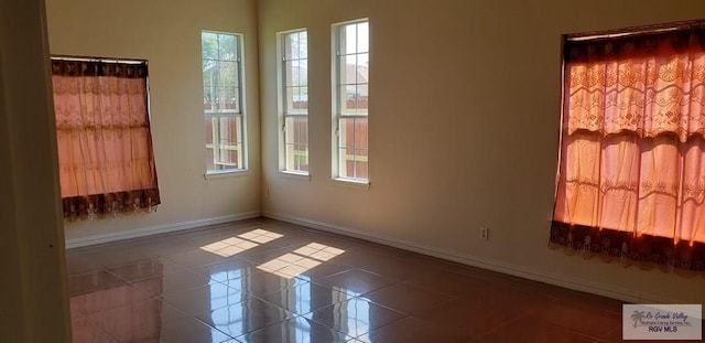 spare room featuring tile patterned flooring