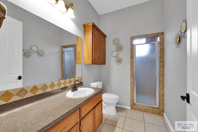 bathroom featuring baseboards, toilet, tile patterned floors, vanity, and a shower stall