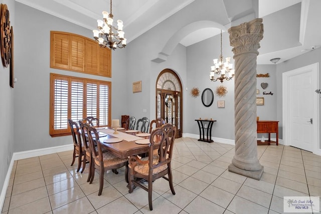 dining area with arched walkways, light tile patterned floors, ornate columns, and an inviting chandelier