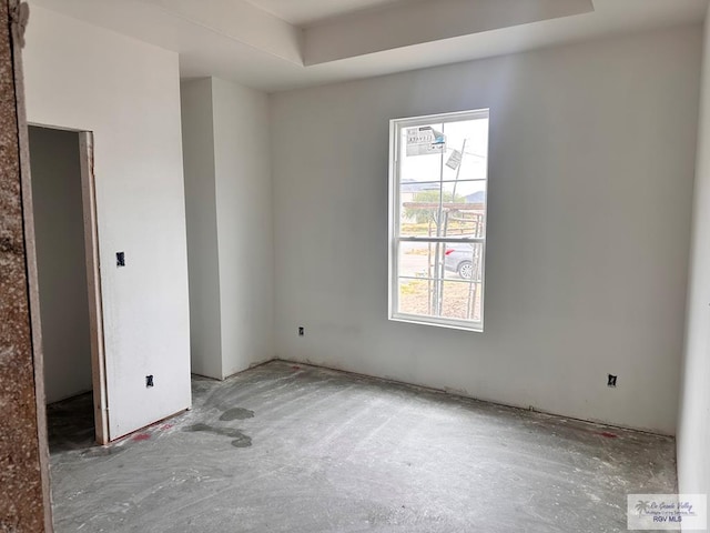 unfurnished room featuring a tray ceiling