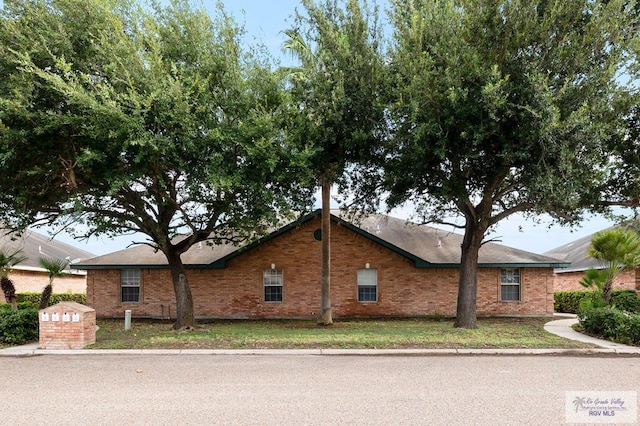 view of side of property with a lawn