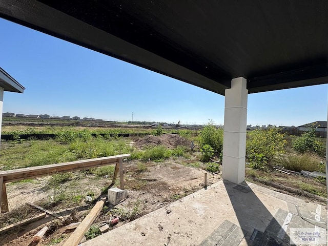 view of yard featuring a rural view and a patio