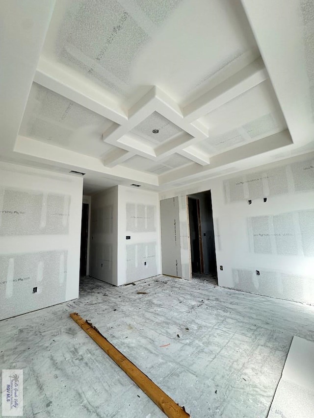 empty room featuring coffered ceiling